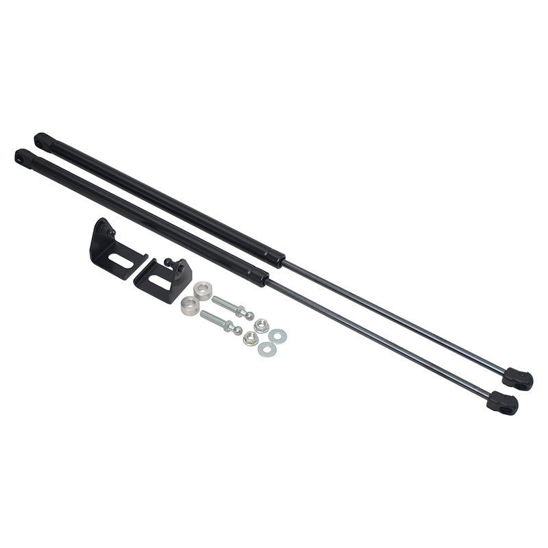 A kit for a vehicle application, likely a tailgate or hood lift support system, displayed on a white background. The components include a pair of black gas struts/dampers with ball socket ends, two small black metal mounting brackets, and an assortment of bolts, nuts, and washers for installation.