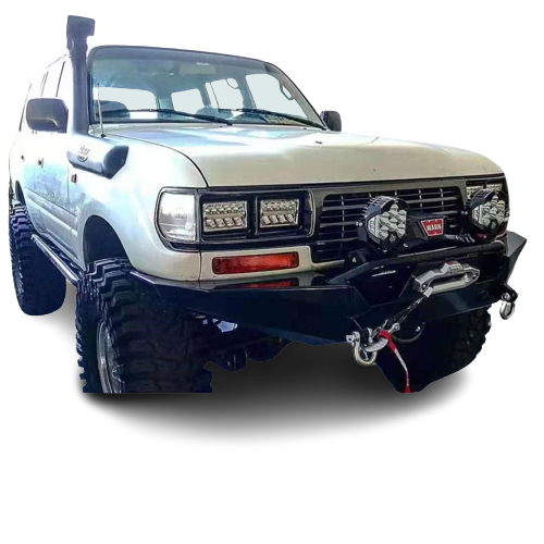 Front-quarter view of a white, lifted Toyota Land Cruiser 80-Series heavily modified for off-roading. It is equipped with a snorkel, massive mud-terrain tires, a rock slider/side step, a rugged black steel front bumper holding a winch, two large round LED auxiliary lights, and rectangular LED light bars integrated into the grille area. The vehicle is shown against a checkered transparency pattern.
