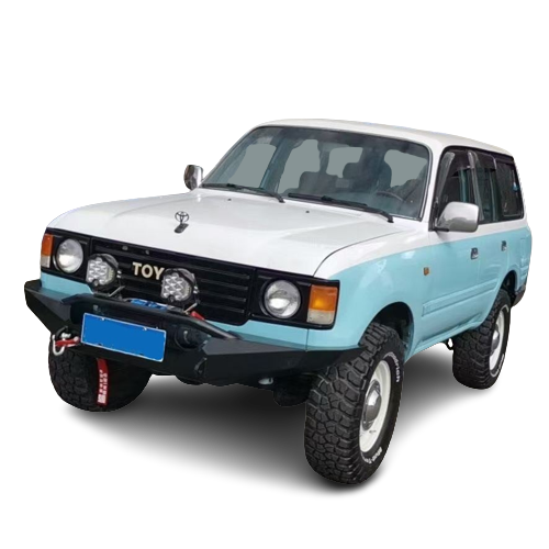 Front-quarter view of a vintage-style, two-tone Toyota Land Cruiser (likely 60-Series or early 80-Series) painted white on top and light blue/mint on the bottom. It is modified for off-roading with a heavy-duty black steel front bumper, two large round auxiliary lights, off-road tires, and a lift kit. The license plate area on the bumper is redacted. The background is a checkered transparency pattern.