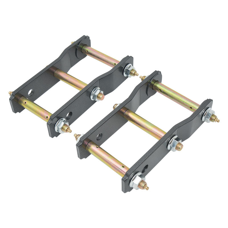 A pair of heavy-duty, dark gray metal shackles (or lift shackles) typically used for vehicle suspension. Each shackle consists of two parallel metal plates connected by two gold-colored bolts/pins (shackle pins), secured with nuts and washers at the ends. The pins appear to have grease fittings (or Zerk fittings) on the outside ends for lubrication. The components are assembled and ready for installation.