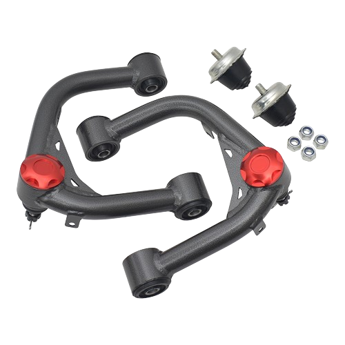 A pair of heavy-duty, dark gray aftermarket upper control arms for a truck or SUV, featuring red anodized dust caps on the ball joint area. The control arms have pre-installed rubber bushings at the chassis mounts. Also included in the image are two smaller, black and silver bushings/mounts and a set of four silver nuts. The control arms have a bent, tubular design.
