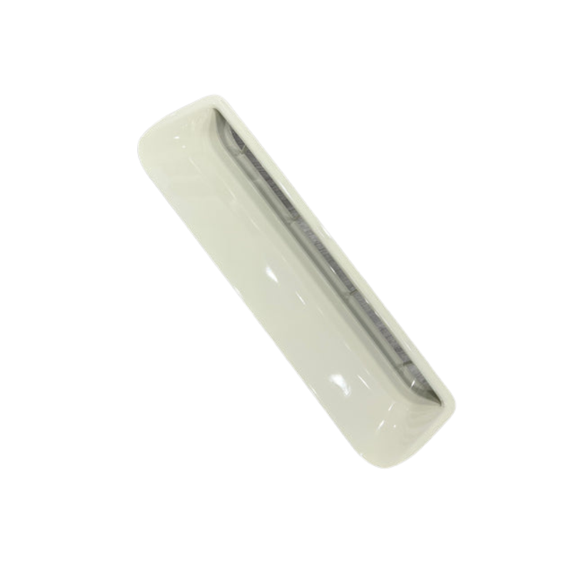 A top-down view of a long, rectangular object, likely a light-colored (white or cream) plastic vent or air grille. It has a smooth, curved outer casing and features a narrow, dark, recessed opening or slit running down the center, which contains an inner mechanism or slats.