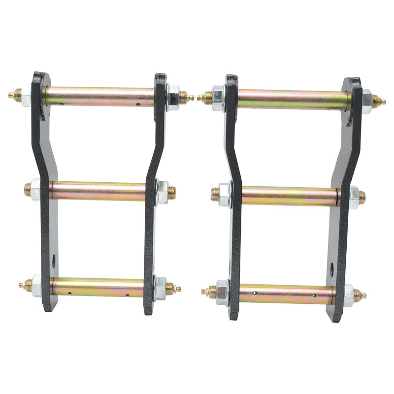 Two identical, heavy-duty black metal shackles or lift kits are shown side-by-side, each featuring three horizontal gold or yellow-zinc plated bolts or pins. The bolts pass through holes in the vertical metal arms and are secured with nuts and lock nuts on the outside. Small grease fittings (zerk fittings) are visible on the ends of the bolts. These components are typically used for vehicle suspension, likely to lift the rear of a truck or SUV by extending the leaf spring shackle length.