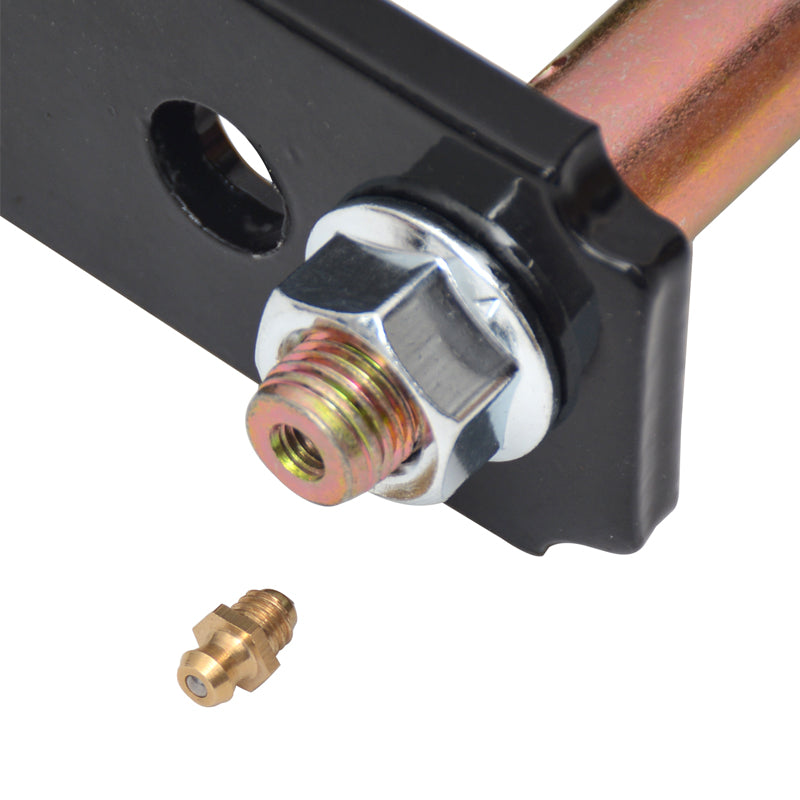 A close-up view showing the threaded end of a gold-colored suspension bolt secured with a silver hexagonal nut against a black metal shackle plate. The bolt features a central threaded opening designed to accept the small, brass zerk fitting (grease nipple) lying directly below it. This setup allows for greasing and lubrication of the suspension component. The background is white.