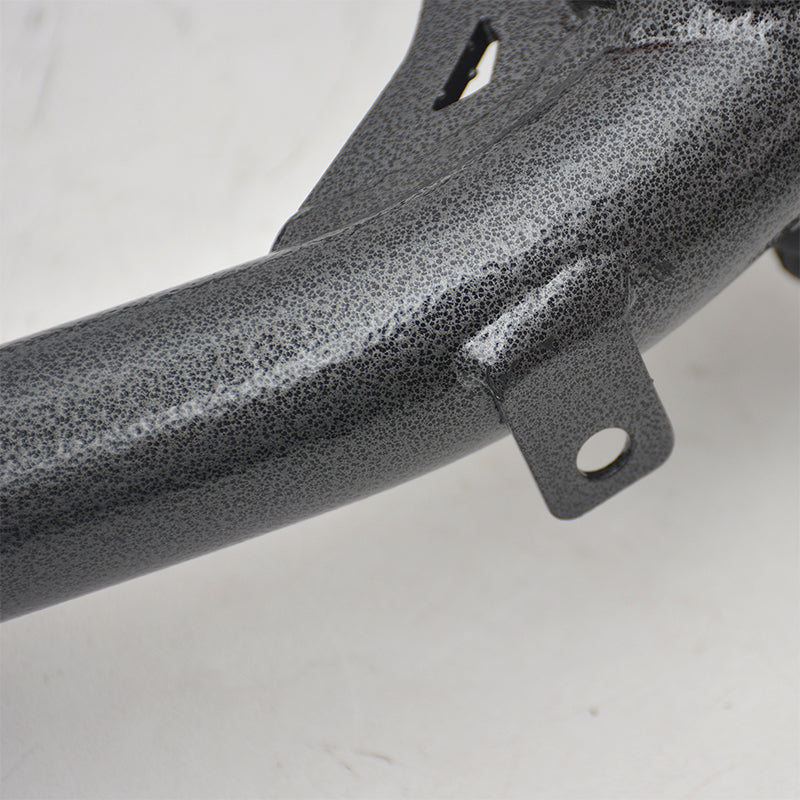 Close-up of a steel vehicle suspension component, likely an aftermarket control arm, finished in a distinctive dark gray or gunmetal gray hammertone or textured powder coat. A small mounting tab with a circular bolt hole is welded onto the side of the main tubular structure.