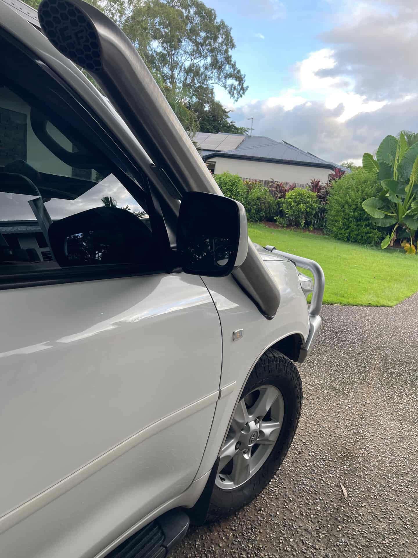 A-pillar view of the Canna Fabrication stainless snorkel on a white Toyota LandCruiser 200 Series