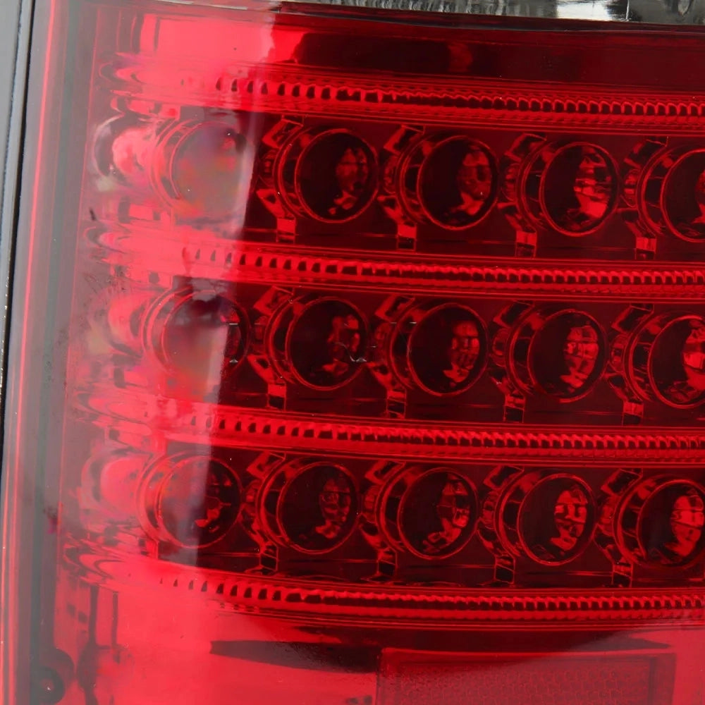 A close-up macro shot of the red LED matrix section of a vehicle taillight. The image shows the texture and detail of the clear lens over the individual circular red LEDs arranged in horizontal rows, with the reflective nature of the lens capturing light.