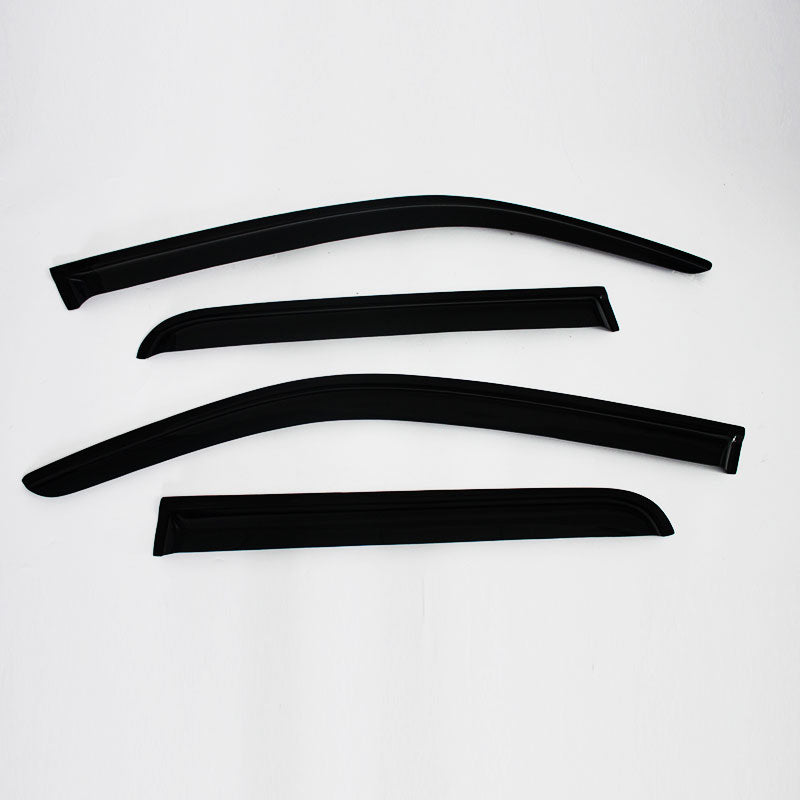 A studio shot of four pieces of tinted, black molded plastic car accessories, likely window visors or rain guards. They are arranged on a white background, appearing in two distinct pairs (one long and one short piece per pair). The pieces have a curved, aerodynamic shape designed to fit along the top edge of car windows.