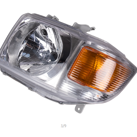 Automotive headlight assembly with a clear lens and a large integrated amber turn signal lens on the right, viewed at an angle against a white background. The assembly has a light gray plastic housing and a faceted reflector for the main beam.