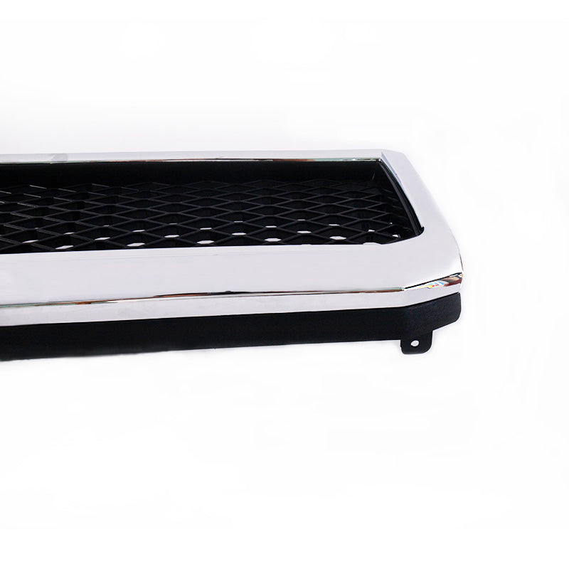 A very close-up corner view of a vehicle grille insert against a white background. The piece features a glossy, thick chrome bezel surrounding a center area with a black diamond mesh pattern. The underside of the piece is black plastic.