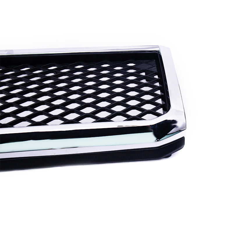 A high-resolution close-up of the corner of a vehicle grille insert. It features a reflective chrome or polished silver border surrounding a center area composed of a clear, open black diamond mesh pattern. The product is isolated against a white background.