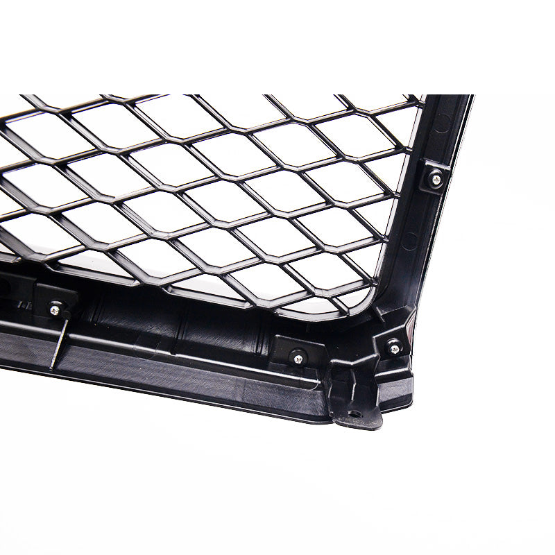A detailed close-up showing the corner of a black plastic vehicle grille or grille insert, isolated on a white background. The front features a deep, structured diamond mesh pattern, while the side reveals the thick plastic structure with several circular mounting points and an attachment tab.