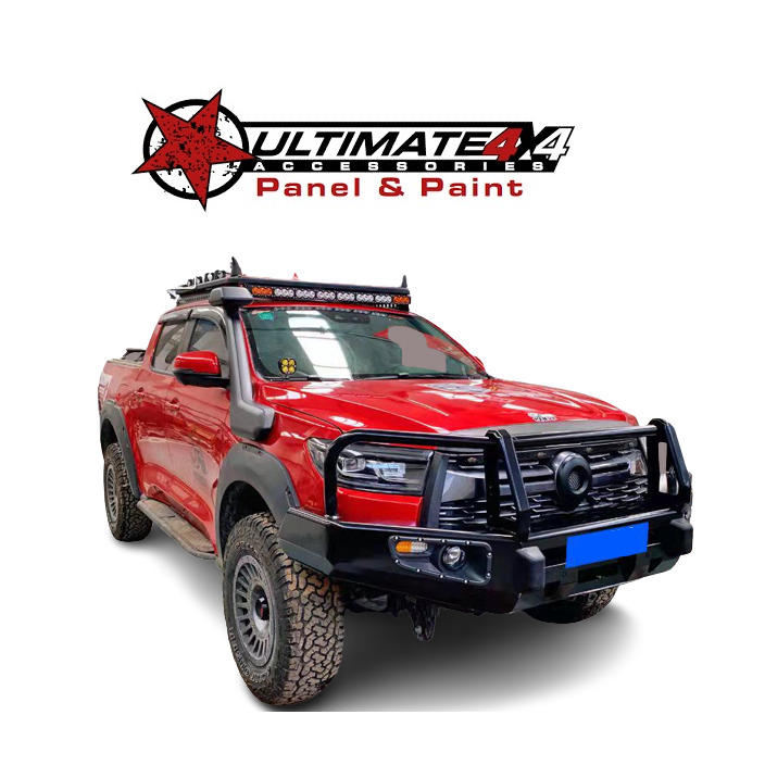 A red 4x4 pickup truck/utility vehicle is shown, highly modified for off-road use.
The vehicle features several accessories, including:
A large, black steel bull bar/replacement front bumper with a wrap-around protective hoop.
Flared wheel arches covering aggressive all-terrain tires mounted on aftermarket wheels.
A black snorkel on the driver's side.
A roof rack with a long LED light bar mounted on top.
Side steps are visible along the bottom edge of the cab.
