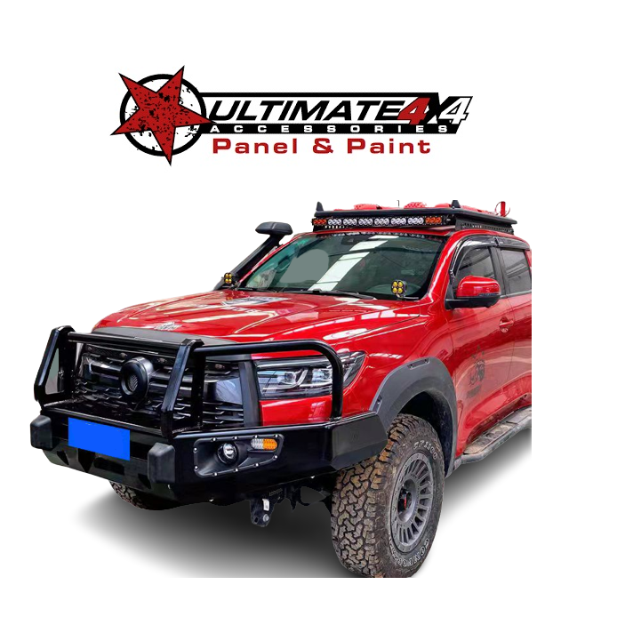 A red 4x4 SUV (likely a Toyota Land Cruiser) is shown, heavily customized with off-road accessories.
Key features visible include:
A large, black steel bull bar/replacement front bumper with a protective hoop/A-frame and integrated lights.
Wide fender flares over off-road tires and aftermarket wheels.
A snorkel mounted on the A-pillar/driver's side.
A roof rack with a long LED light bar mounted on it.
Auxiliary driving lights mounted on the bull bar.