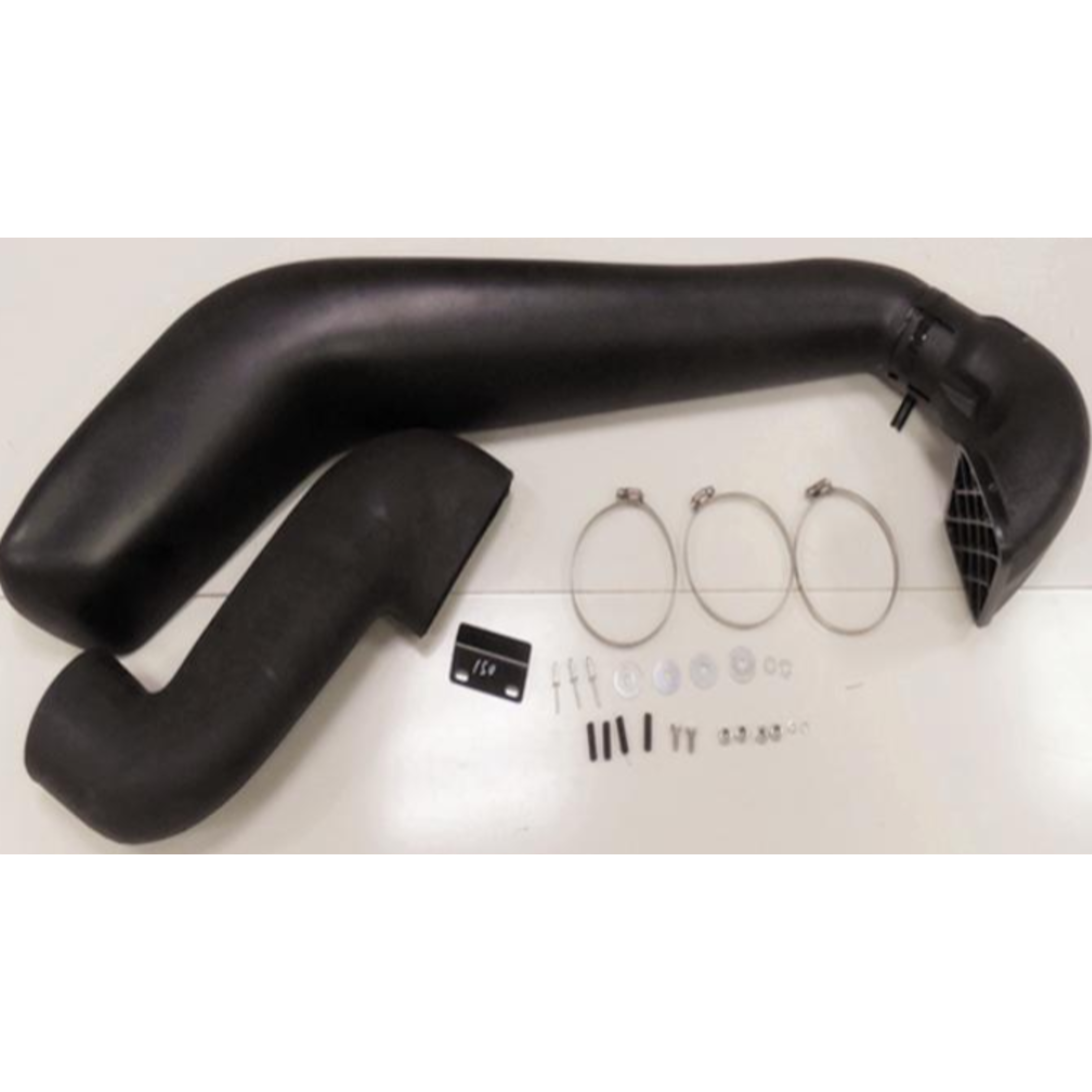 An overhead shot of an automotive snorkel kit laid out on a white surface. The kit consists primarily of two large, curved black plastic pipes (the main snorkel body and a connecting piece). To the right, there is a collection of installation hardware, including three large metal hose clamps, screws, fasteners, washers, and a small black mounting bracket labeled '150'.