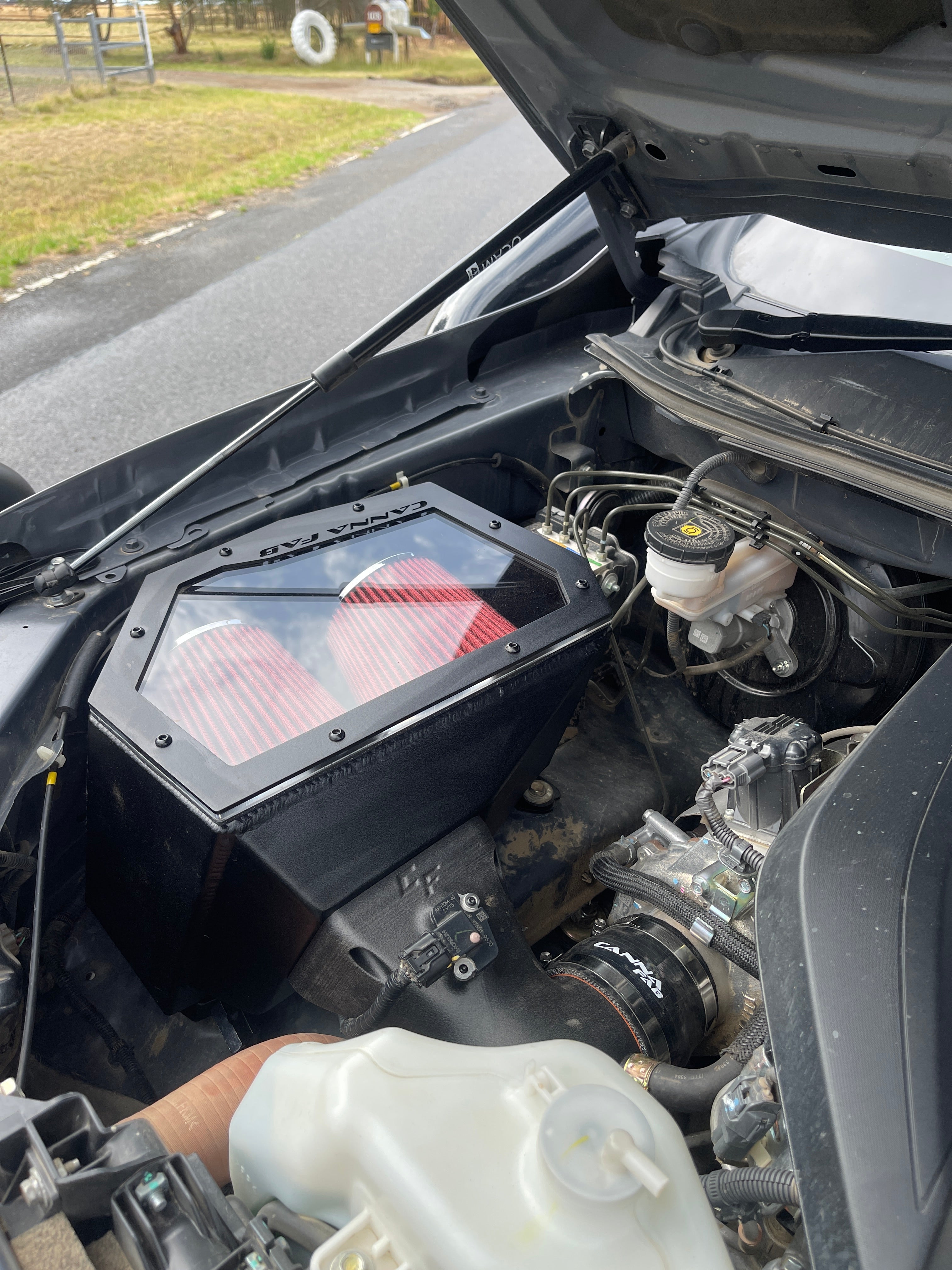 Canna Fabrication twin-pod filter aftermarket airbox with red pod filters installed in a 4WD engine bay (BT-50 / D-Max)