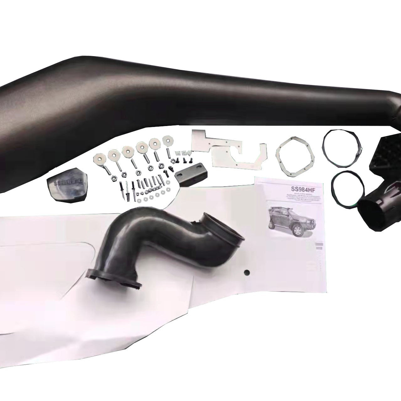 An overhead flat lay of a complete black automotive snorkel kit (SS984HF), with components arranged on a white background. Key visible parts include the large, curved main snorkel body, a black elbow air duct, a collection of mounting hardware (bolts, washers, nuts, and a small metal bracket), a paper instruction manual showing a 4x4 vehicle, a large paper installation template, and several rubber seals and clamps.